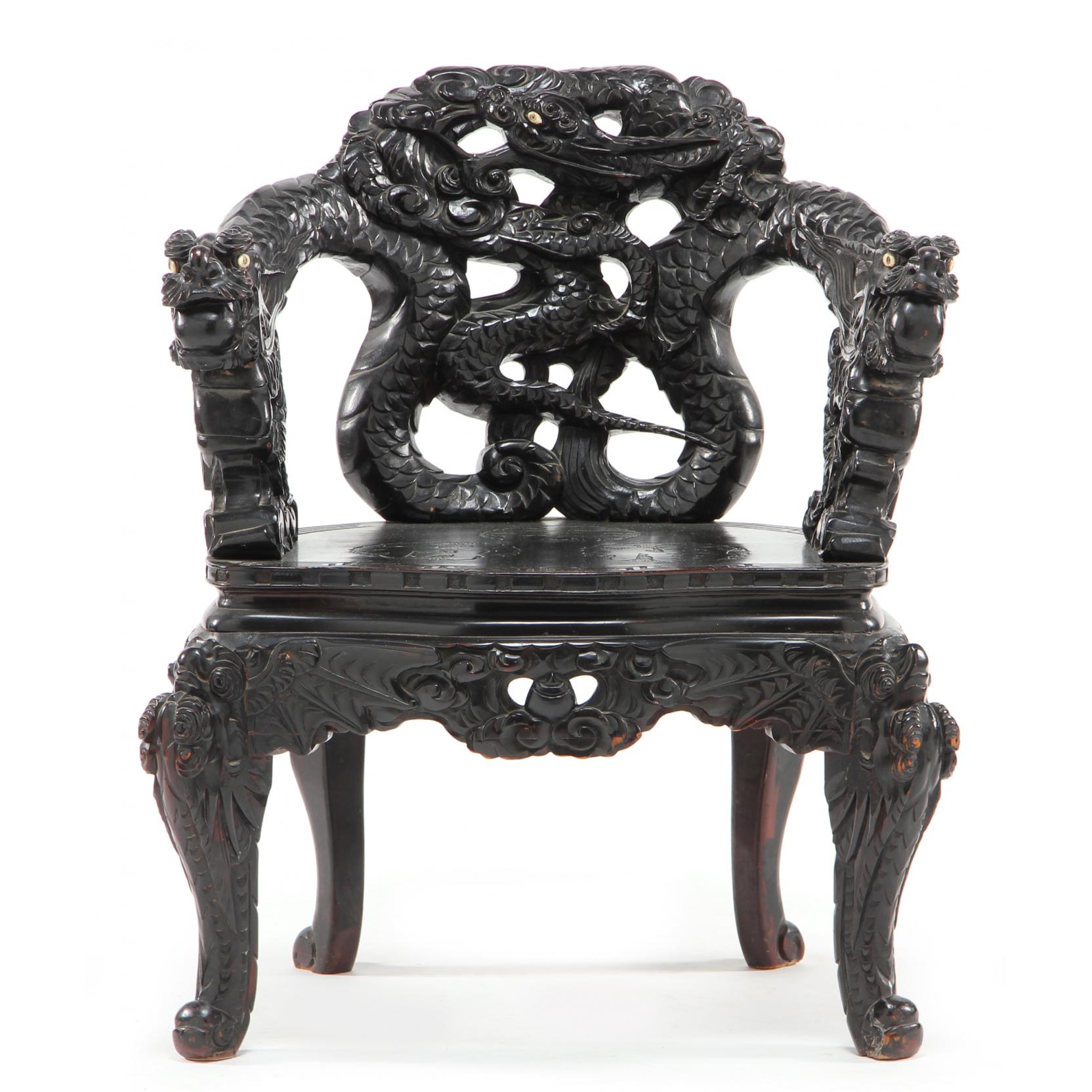 Appraisal: Chinese Heavily Carved Arm Chair early th century ironwood arms