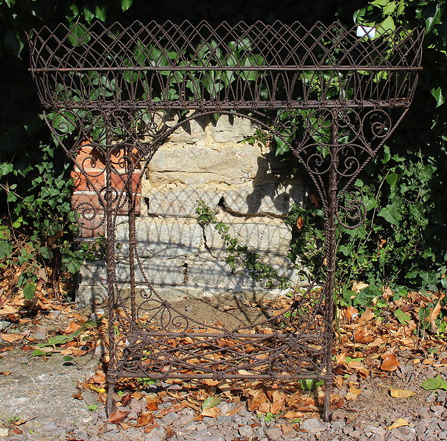 Appraisal: A VICTORIAN WIREWORK PLANT STAND with scrolling supports and lattice