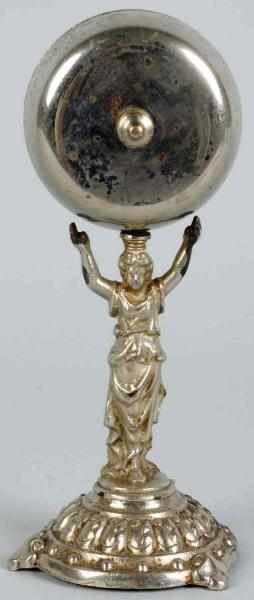 Appraisal: Figural Iron Lady Holding Bell Twist Bell Silver-plated Condition Excellent