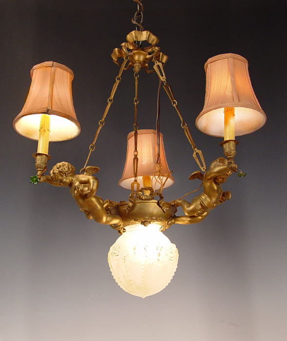 Appraisal: PETITE FRENCH FIGURAL CHANDELIER Three lights supported by putti figures