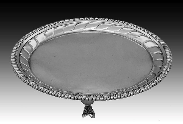 Appraisal: A GEORGE III SILVER WAITER with gadrooned border and further