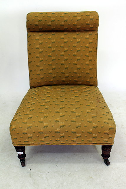 Appraisal: A VICTORIAN NURSING CHAIR upholstered with yellow flowers on a