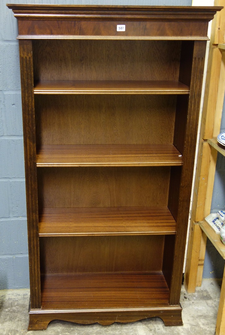 Appraisal: A reproduction mahogany open fronted bookcase with three adjustable shelves