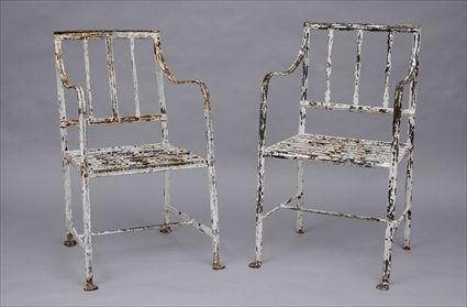 Appraisal: TWO SIMILAR ENGLISH PAINTED WROUGHT-IRON GARDEN ARMCHAIRS Each openwork back