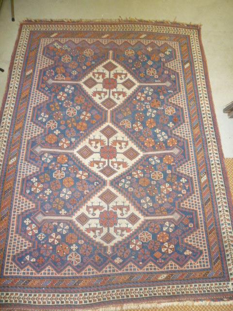 Appraisal: A KAZAK RUG the navy blue field with tribal motifs