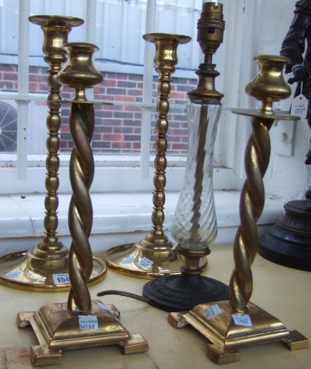 Appraisal: A pair of brass candlesticks with barley-twist columns another pair