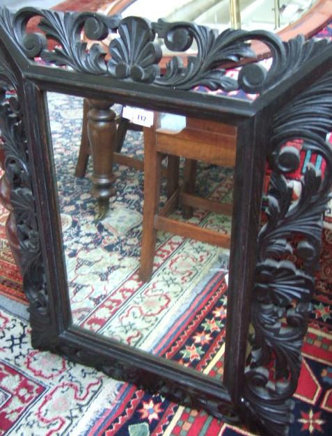 Appraisal: A late Victorian oak wall mirror the backwards swept frame