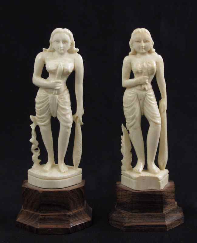 Appraisal: CARVED IVORY FEMALE FIGURES Pair of women holding knife in