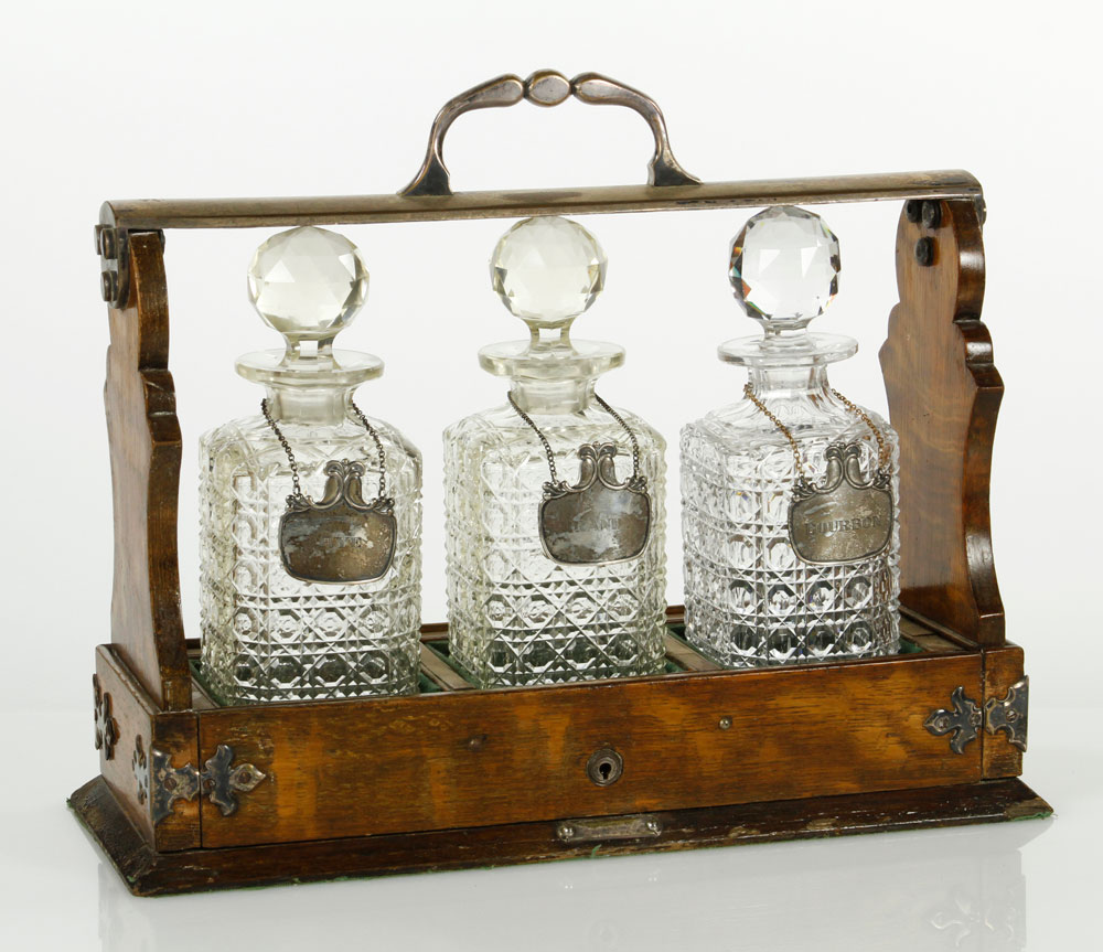 Appraisal: - Bottle Tantalus Silver-trimmed three bottle tantalus in oak case