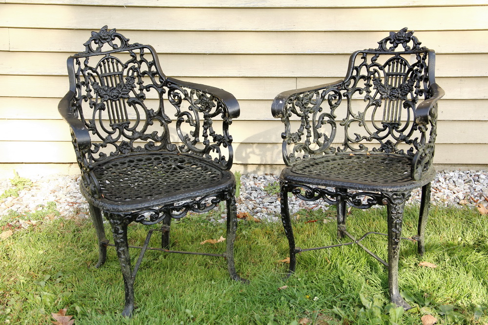 Appraisal: PAIR OF CAST IRON GARDEN CHAIRS - English Lyre Back