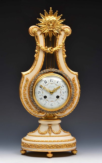 Appraisal: A FRENCH LYRE MANTEL CLOCK the convex white enamel Arabic