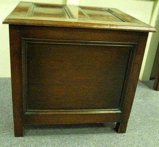 Appraisal: An oak chest the hinged lid over panel sides on