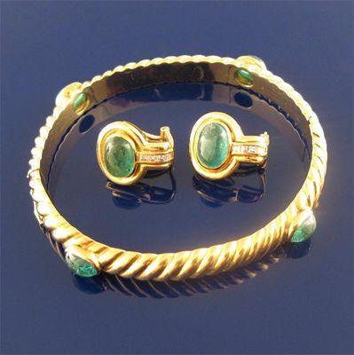 Appraisal: A gold rope design bangle mounted with four cabachon emeralds