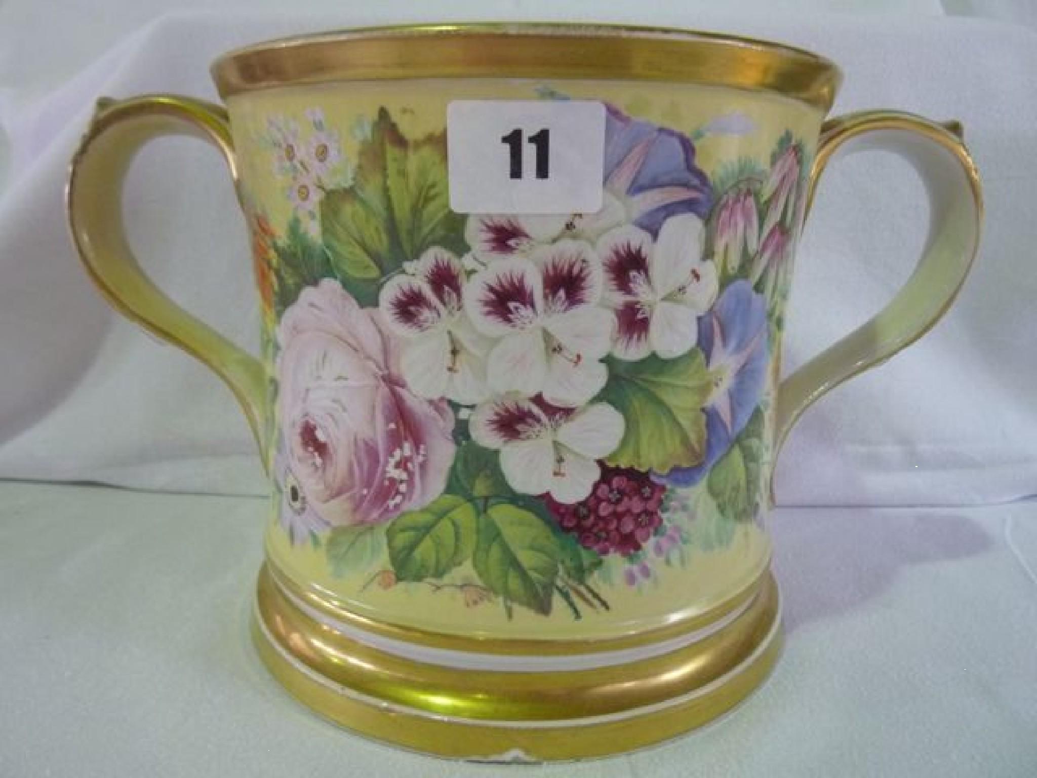 Appraisal: A th century oversized loving cup decorated with flowers flanked