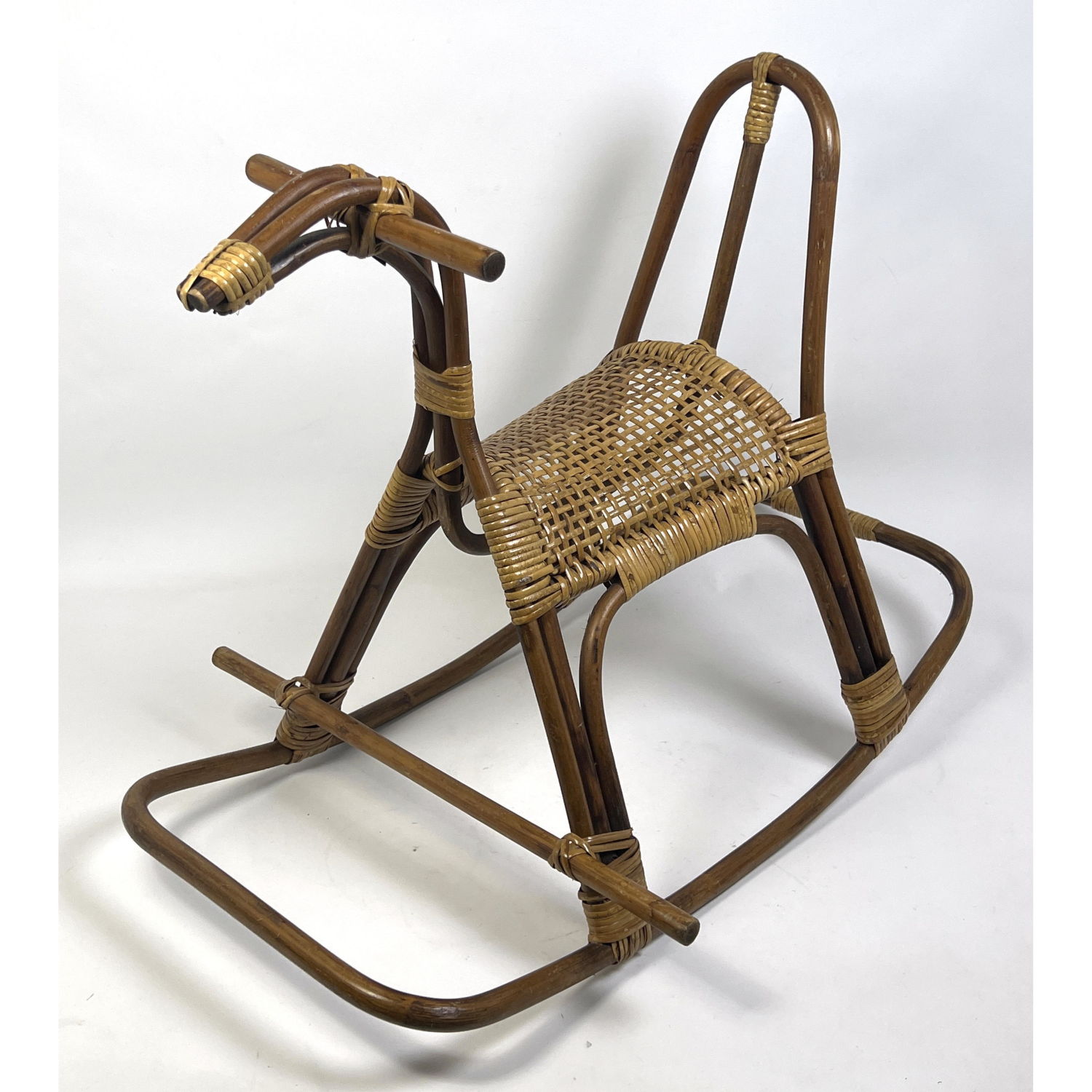 Appraisal: Albini style Bamboo and Rattan Rocking Horse Woven seat and