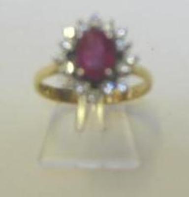 Appraisal: A RUBY AND DIAMOND CLUSTER RING the oval cut ruby