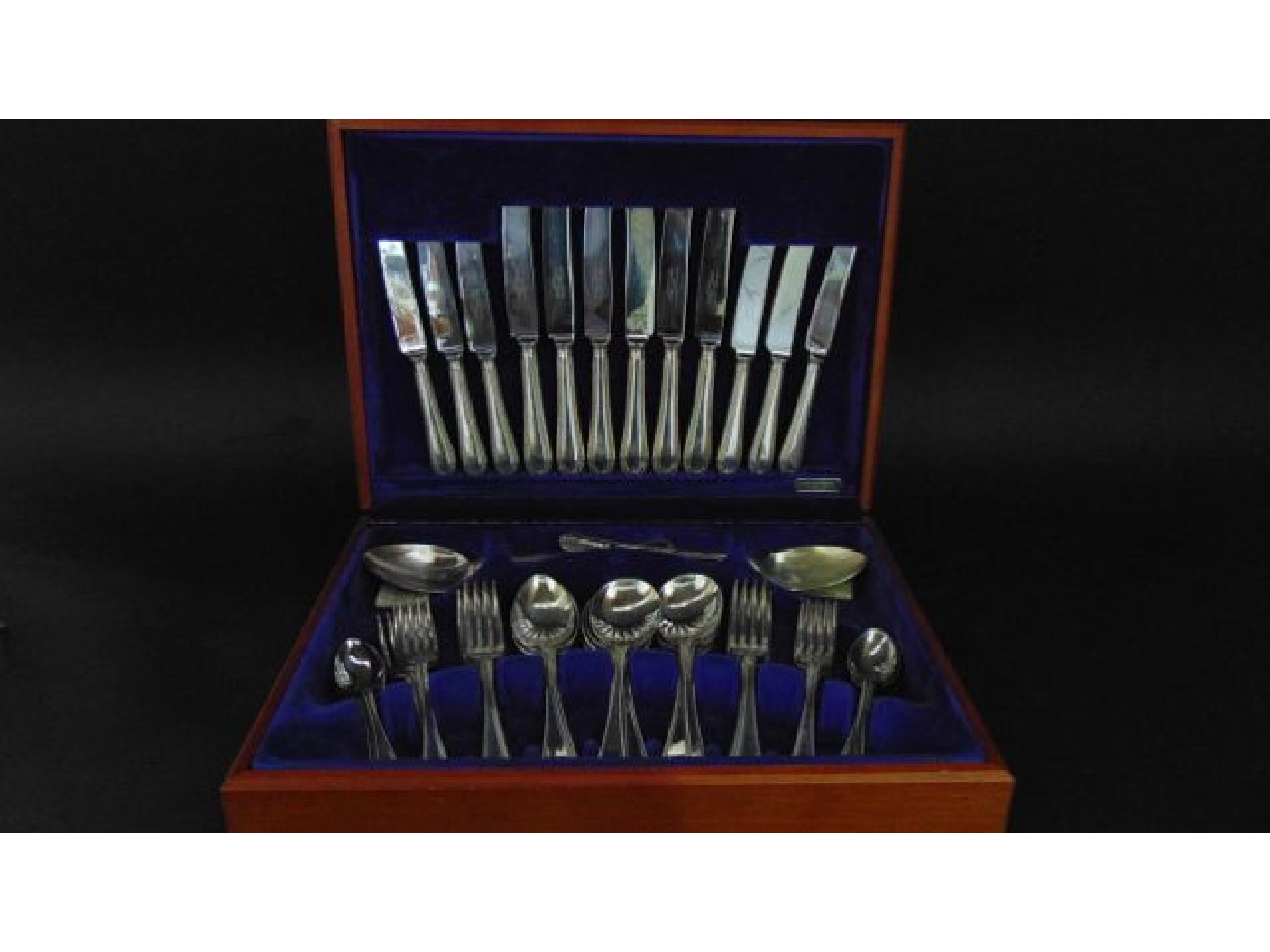 Appraisal: A timber canteen containing a quantity of silver plated cutlery