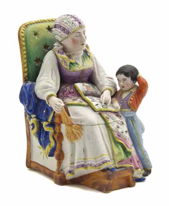 Appraisal: A Continental Porcelain Figural Inkwell depicting a seated woman reading