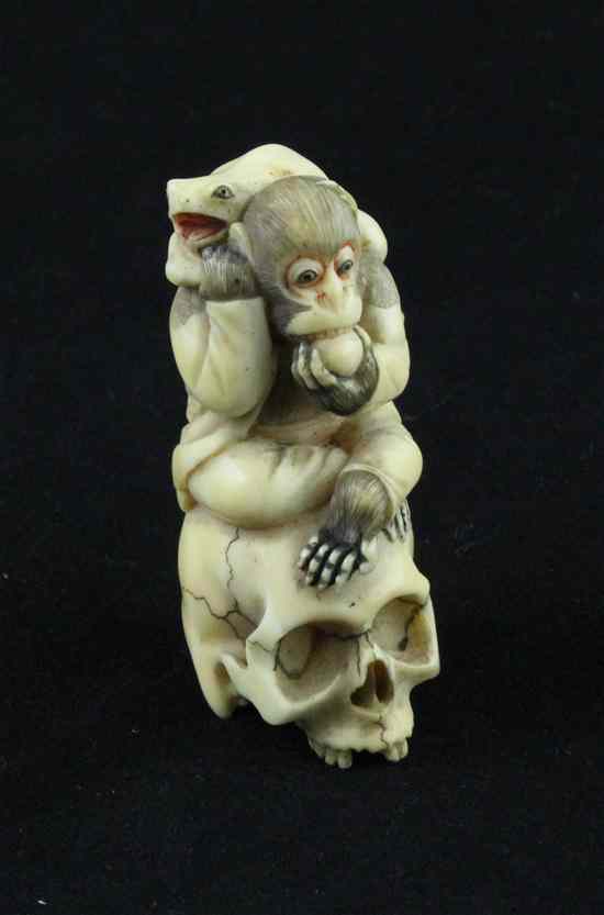 Appraisal: A carved and stained ivory netsuke carved as a monkey