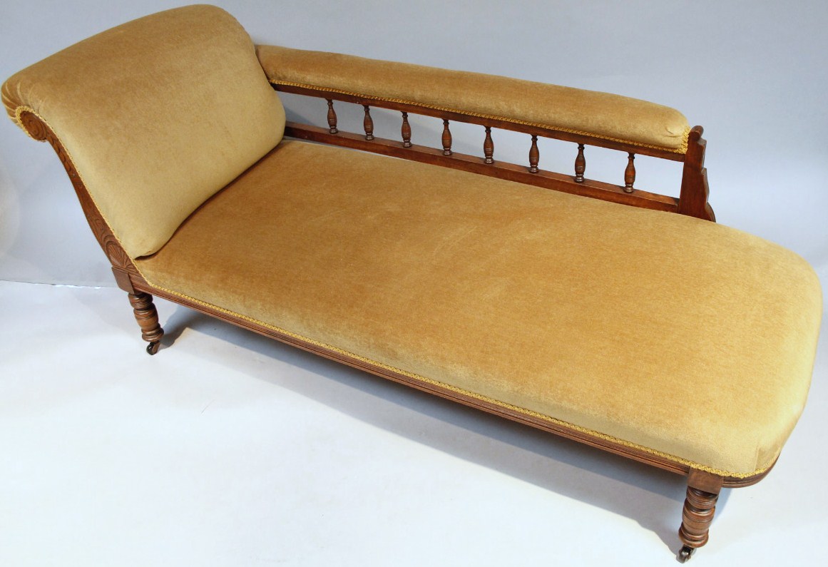 Appraisal: An Edwardian stained walnut chaise longue with scroll side and