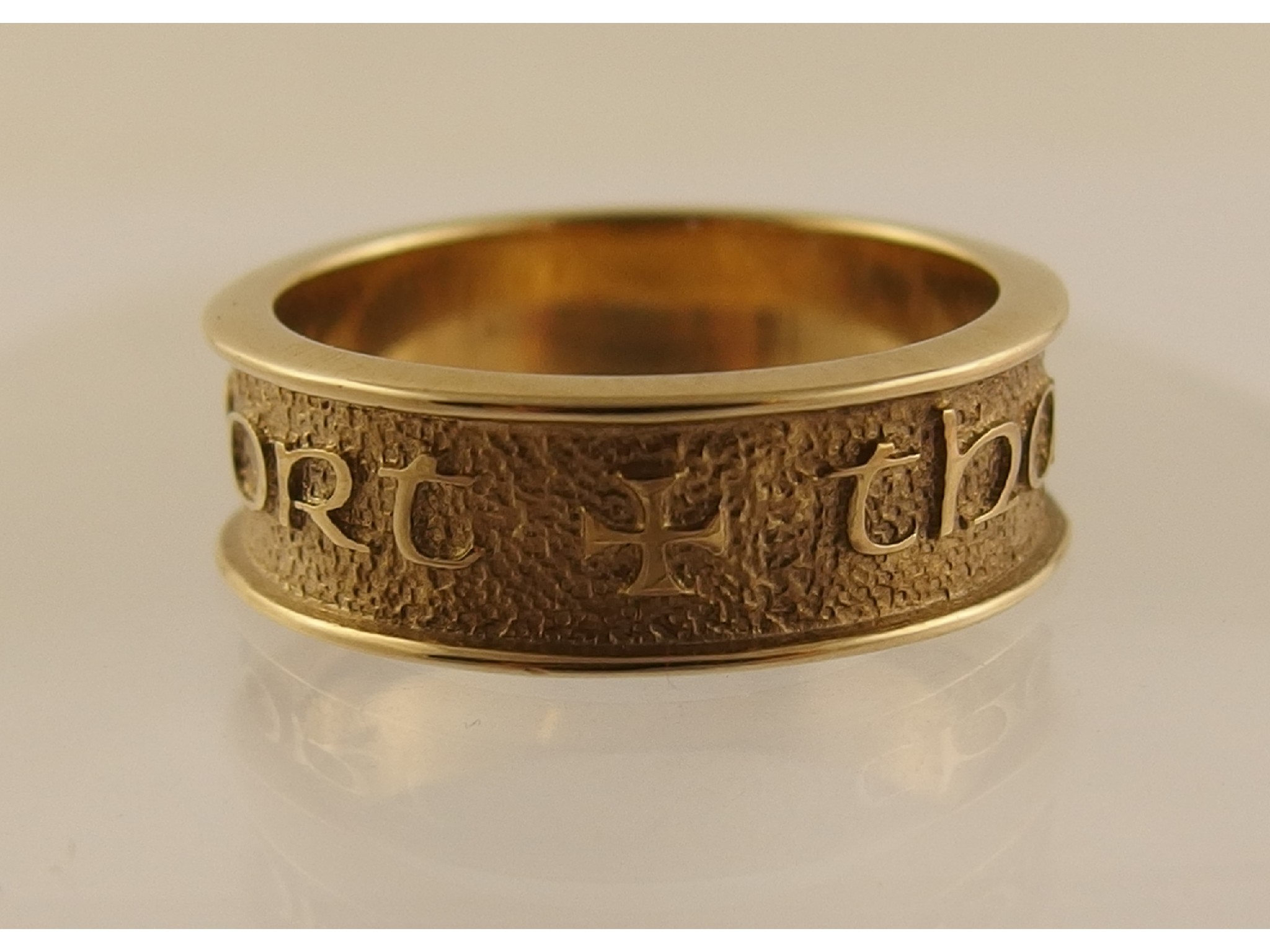 Appraisal: An Ola Gorie ct band ring with the inscription 'Tha