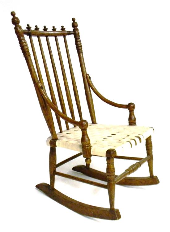 Appraisal: Child's rocking armchair Victorian toprail pierced by five spindles with