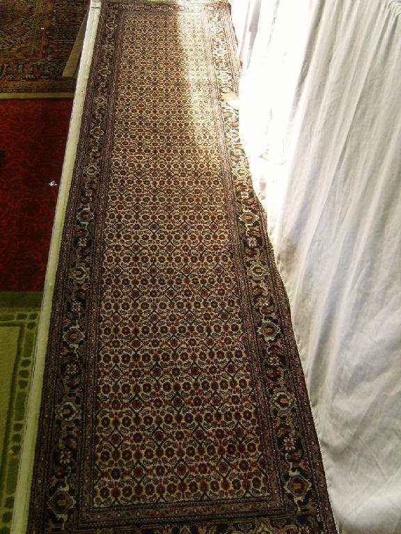 Appraisal: An eastern wool runner with repeating stylised floral decoration in