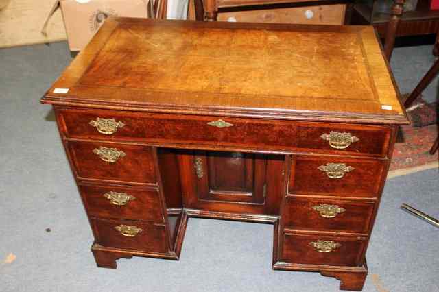 Appraisal: A GEORGIAN WALNUT KNEEHOLE DESK with crossbanded top and one