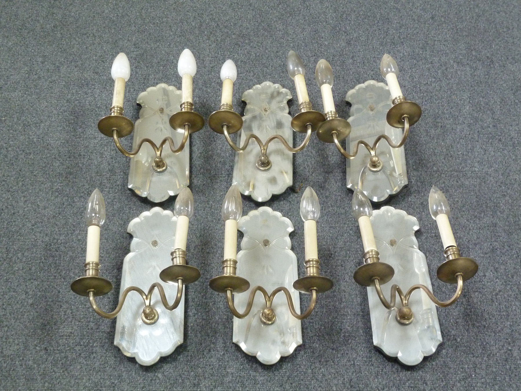 Appraisal: A set of six mirror back wall sconces