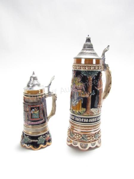 Appraisal: Two Musical Porcelain Steins L depicting figures in forest plays