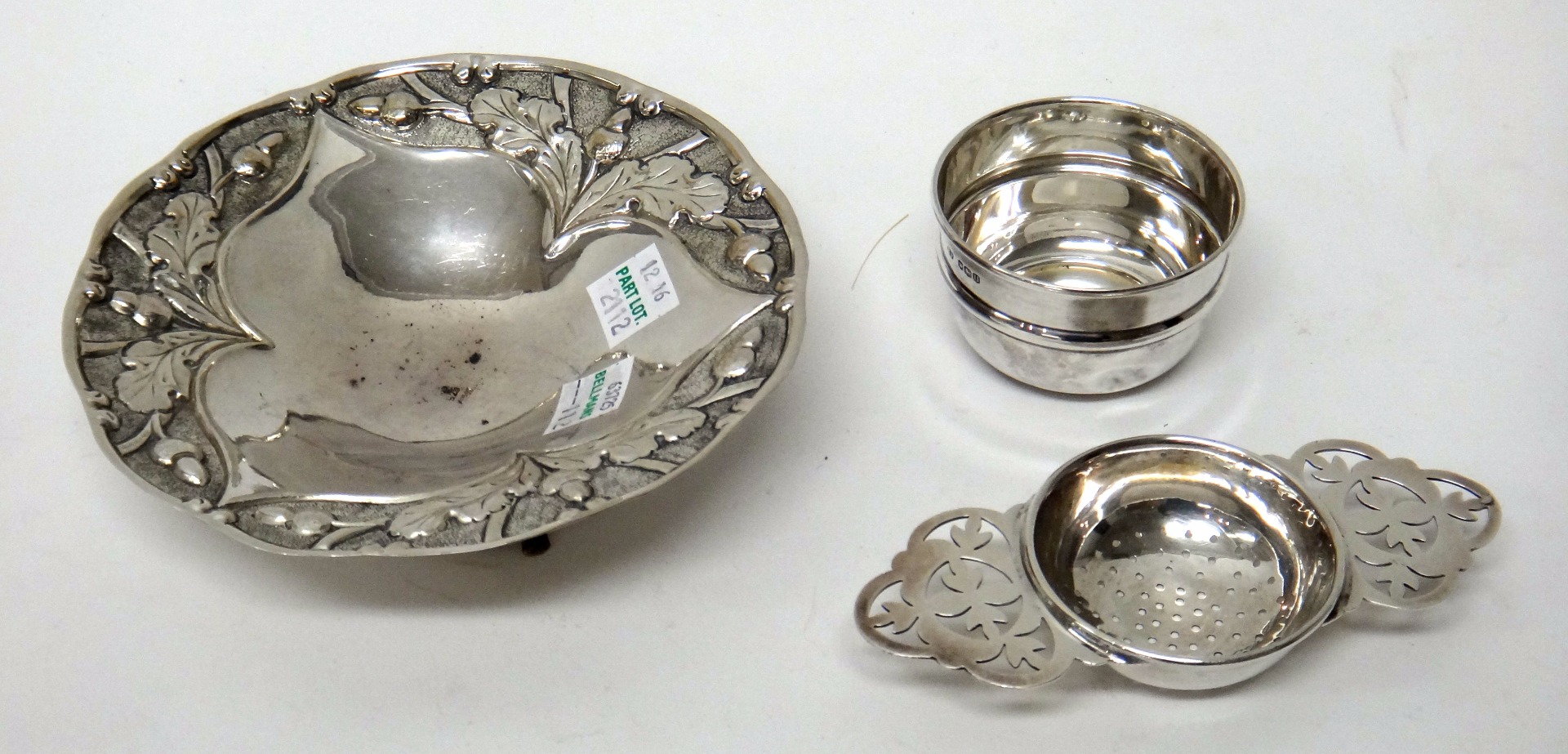 Appraisal: A silver twin handled tea strainer with a silver bowl