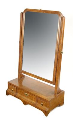 Appraisal: A walnut swing frame dressing table mirror cross and feather