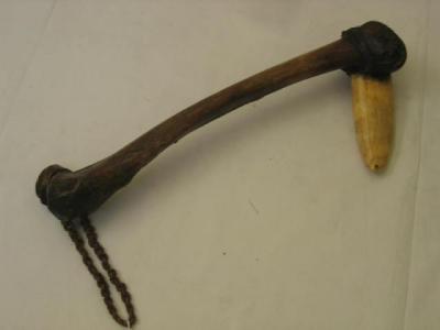 Appraisal: A TRIBAL CLUB with horn blade and bone handle possibly