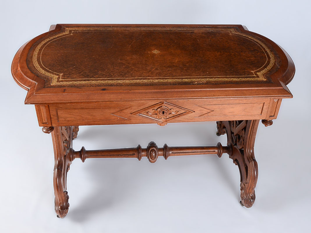 Appraisal: VICTORIAN CARVED WALNUT WRITING DESK Embossed inset brown leather top