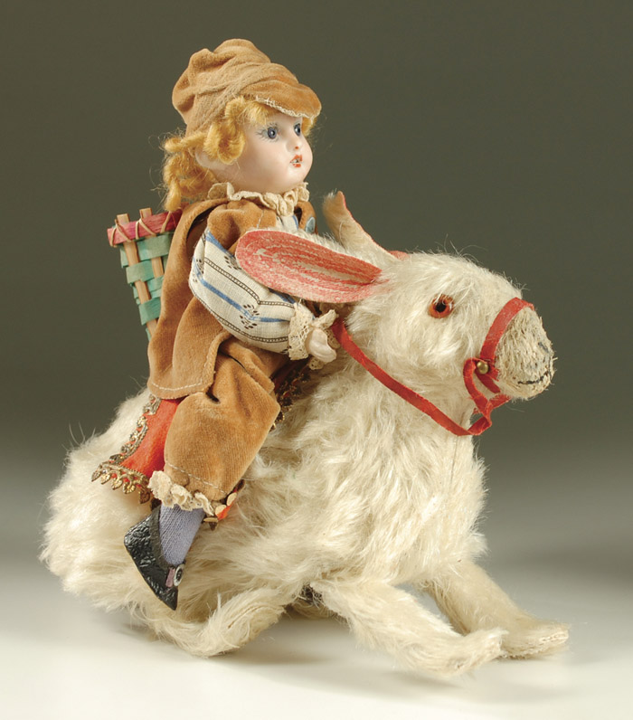 Appraisal: GERMAN AUTOMATON BISQUE HEAD DOLL ON RABBIT the boy doll