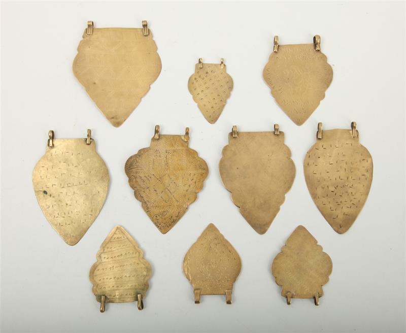 Appraisal: GROUP OF TEN PERSIAN ENGRAVED BRASS TEAR-FORM PENDANTS Variously decorated