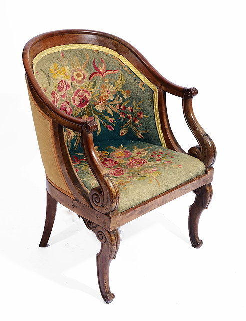 Appraisal: A FRENCH EMPIRE MAHOGANY TUB CHAIR with shaped back scroll