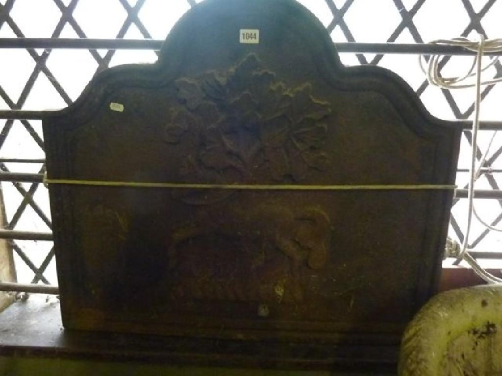 Appraisal: A heavy reproduction cast iron fire back with arched outline