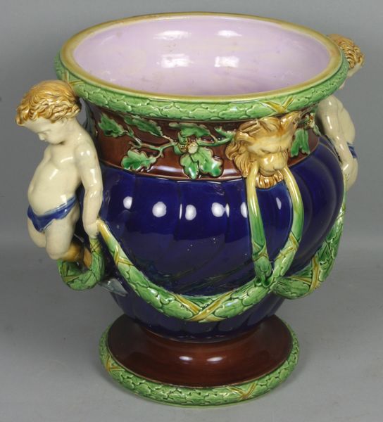 Appraisal: th Century Minton Majolica JardiniFre with applied putti h Good