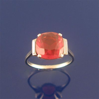 Appraisal: A fire opal and diamond ring cushioned shaped fire opal