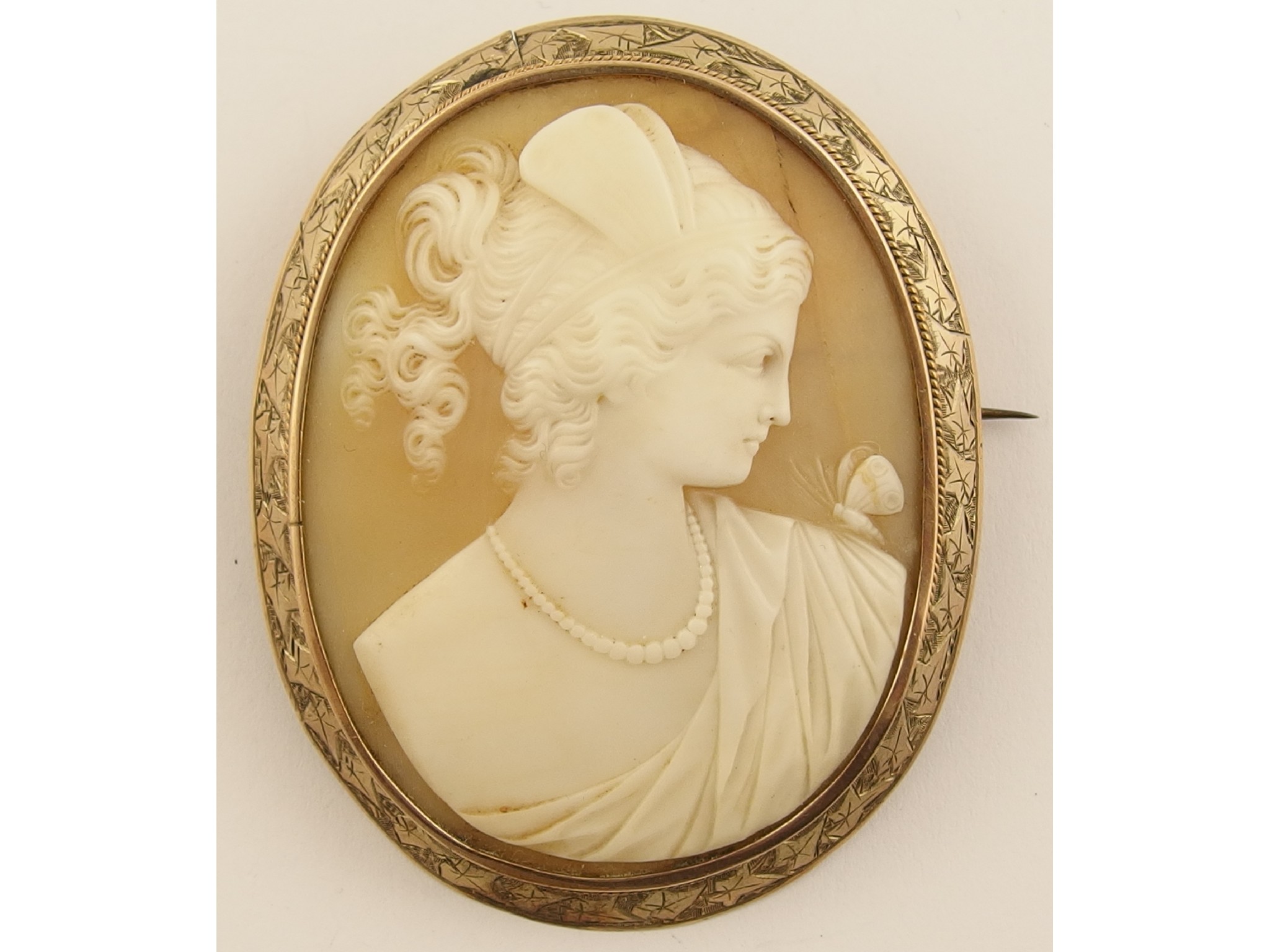 Appraisal: A large shell cameo brooch depicting the goddess psyche in