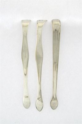 Appraisal: Three pairs of George III silver sugar tongs by Peter