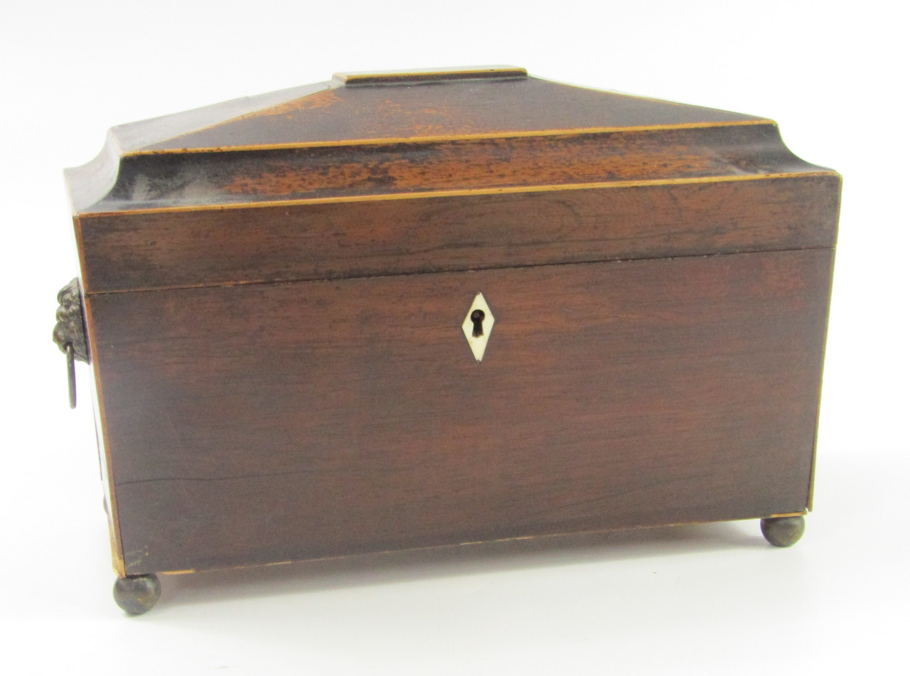 Appraisal: A Regency rosewood sarcophagus tea caddy with brass lion's head