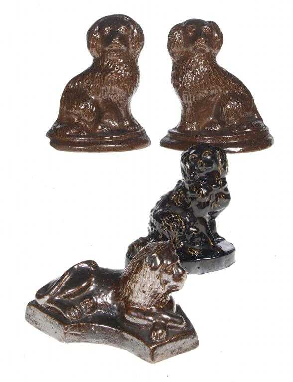 Appraisal: A PAIR OF SALTGLAZED BROWN STONEWARE SEATED SPANIEL DOOR STOPS