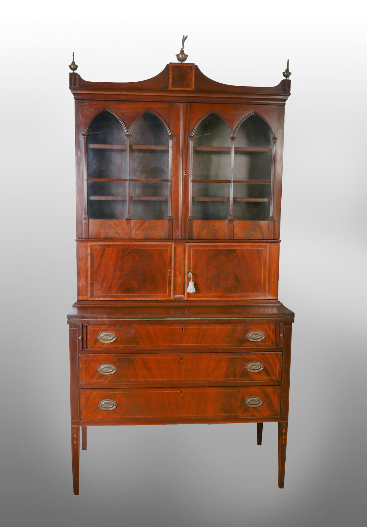 Appraisal: SHERATON STYLE SECRETARY DESK CABINET Surmounting brass finials with an