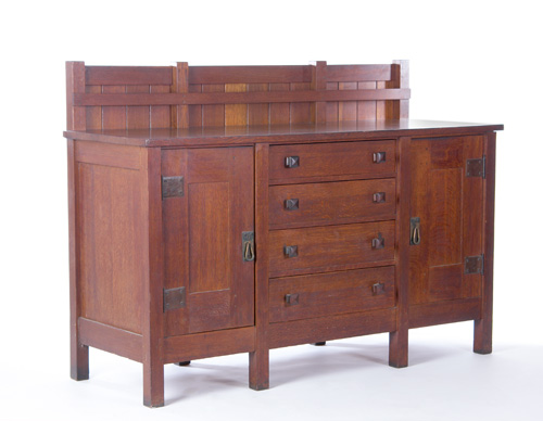 Appraisal: GUSTAV STICKLEY Eight-leg sideboard with four central drawers having faceted