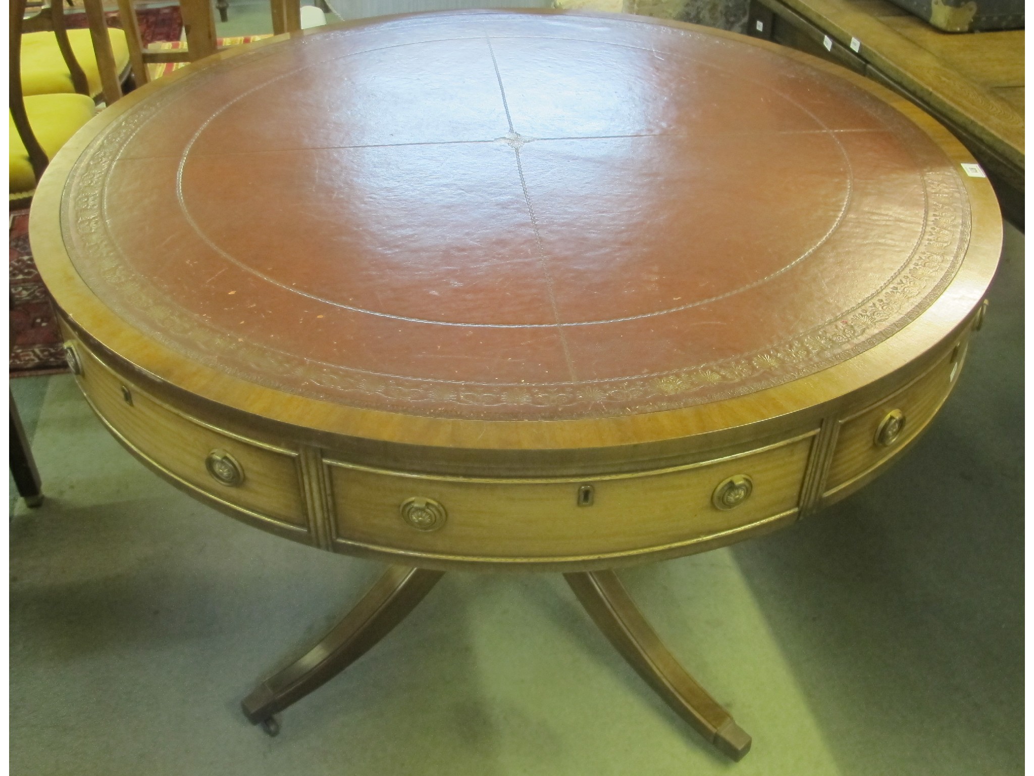 Appraisal: A mahogany library drum table with leather top