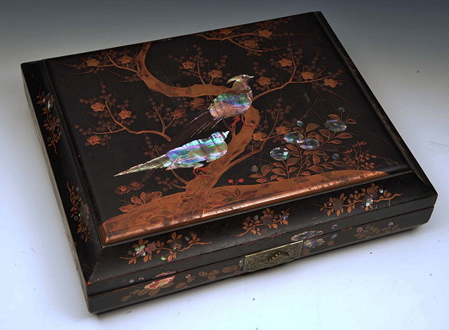 Appraisal: A JAPANESE BLACK RECTANGULAR BOX with peacock and blossom decoration