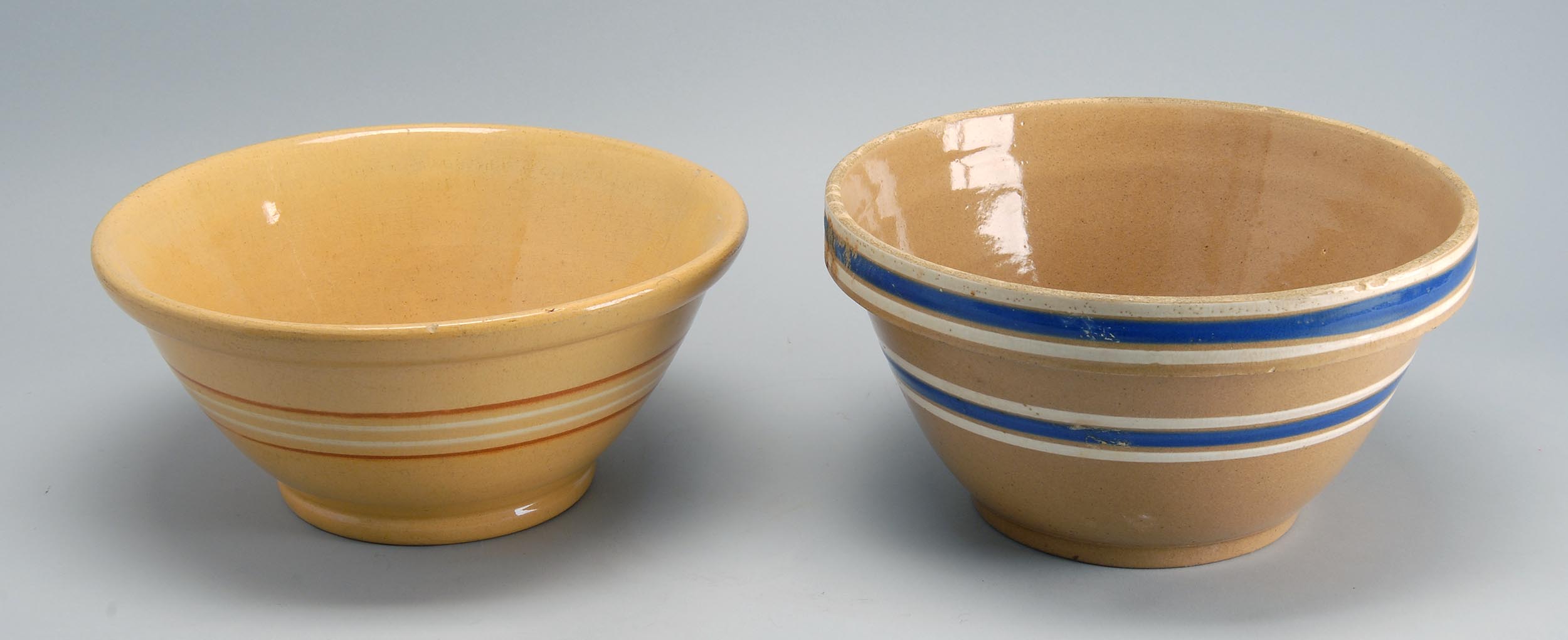 Appraisal: TWO BANDED YELLOWWARE MIXING BOWLS one with brown decoration and