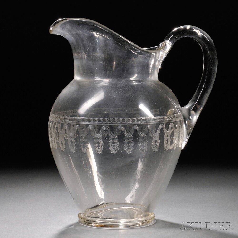 Appraisal: Large Colorless Blown Glass Pitcher with Engraved Decoration mid to